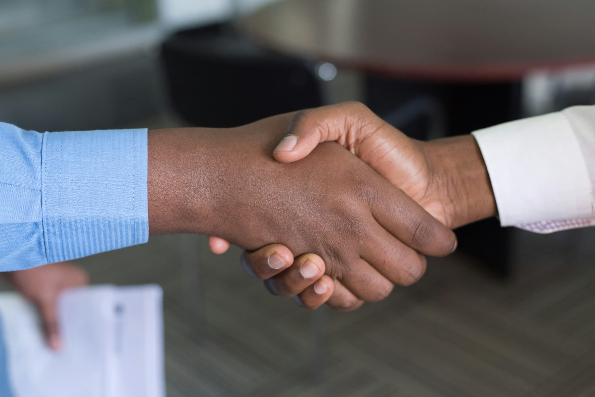 Two people shaking hands in an office in Nairobi